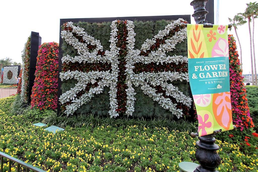 Flag walls of flowers decorate the entrance to World Showcase
