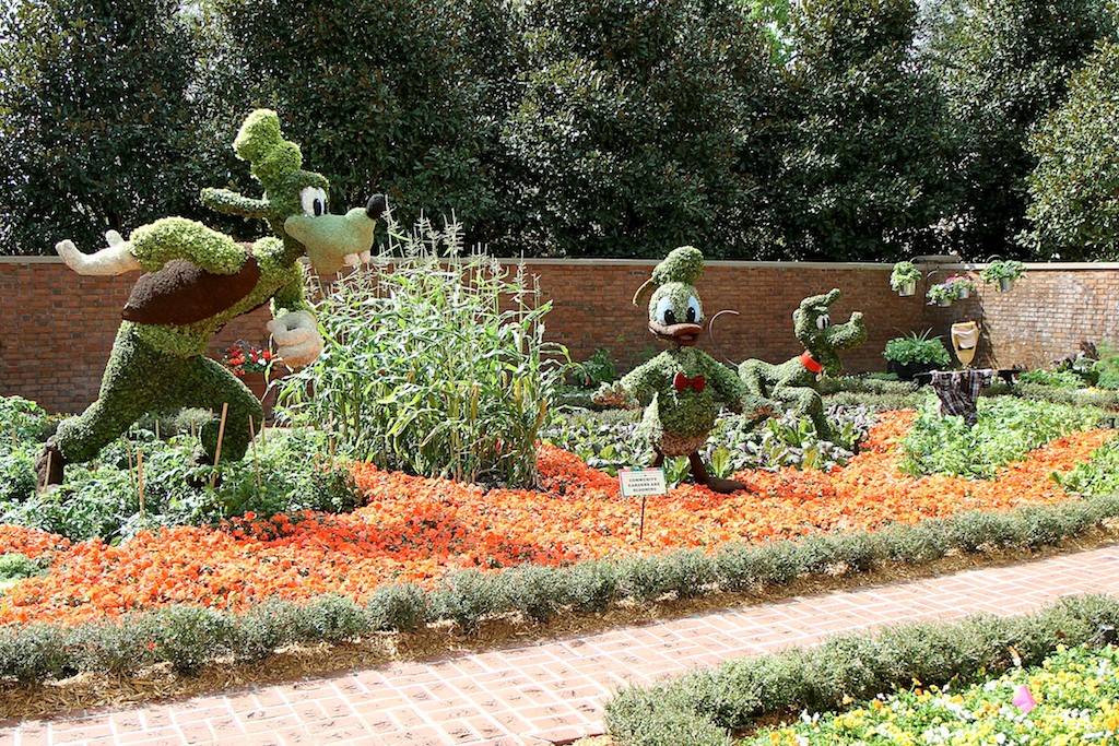 Goofy, Donald and Pluto in the gardens at the American Adventure Pavilion
