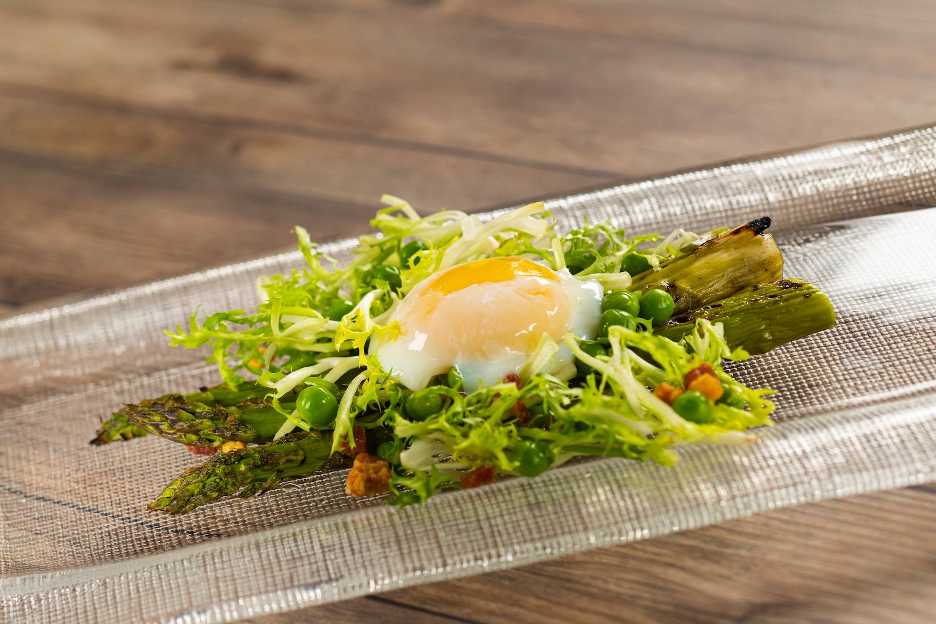 Grilled Asparagus with pancetta bacon, spring peas, frisee lettuce, truffle sherry vinaigrette, and soft-poached egg