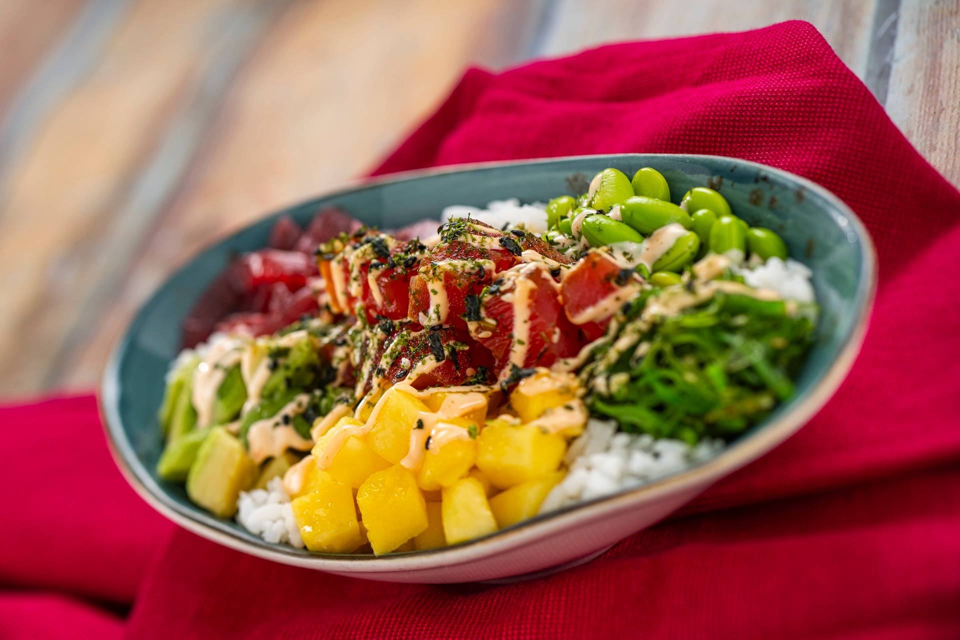 Tuna Poke Bowl with edamame, avocado, mango, pickled red onions, seaweed salad