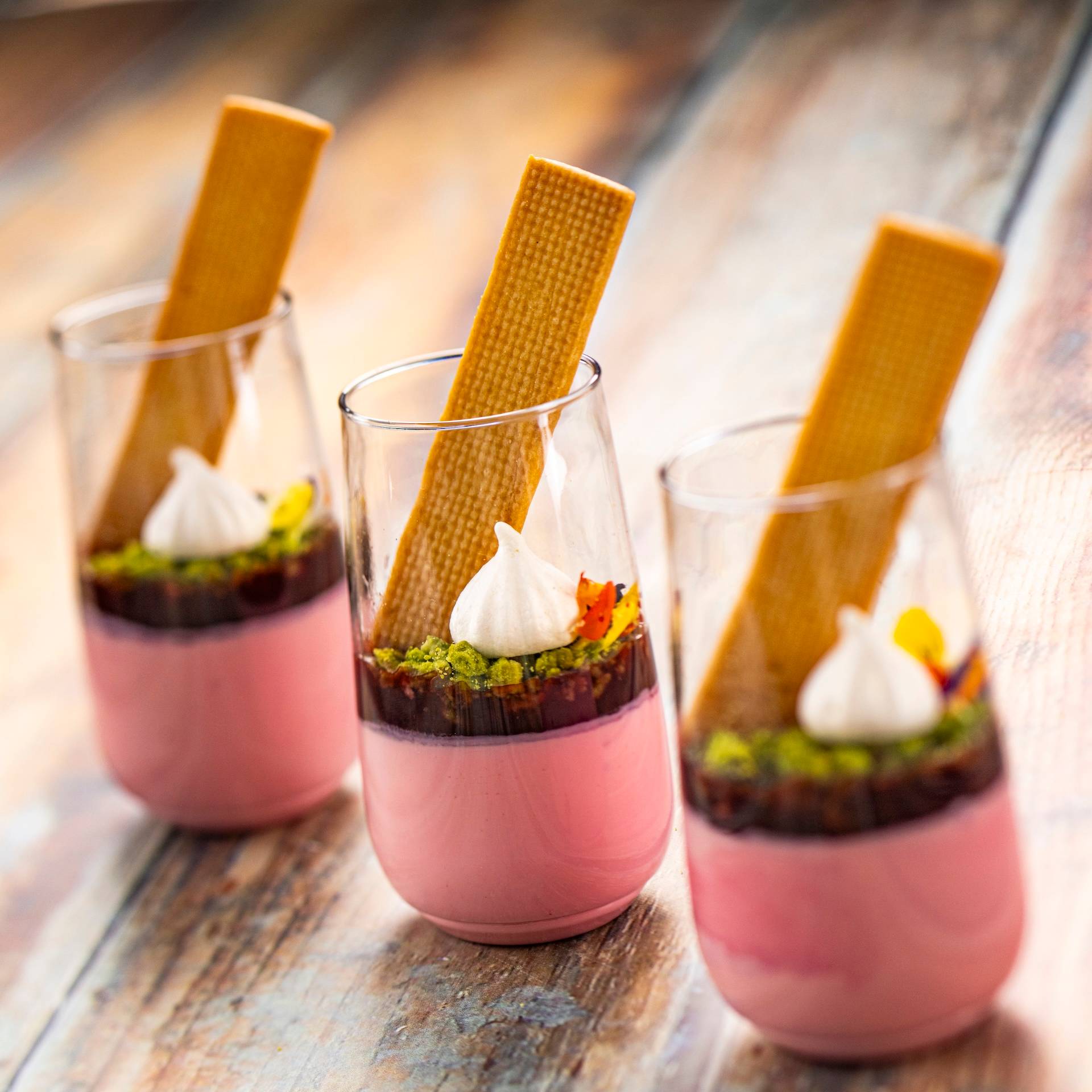 Coconut Panna Cotta with a cherry gelee and matcha crumb topped with a citrus cookie, plant-based meringue, and flower confetti (Plant-based) (New)