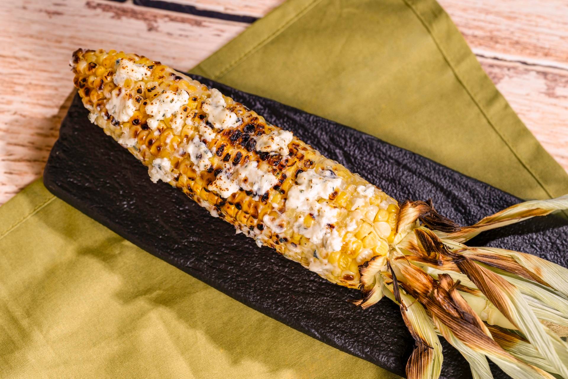 Grilled Street Corn on the Cob with savory garlic spread featuring Boursin Dairy-Free Garlic and Fine Herbs Cheese (Plant-based)