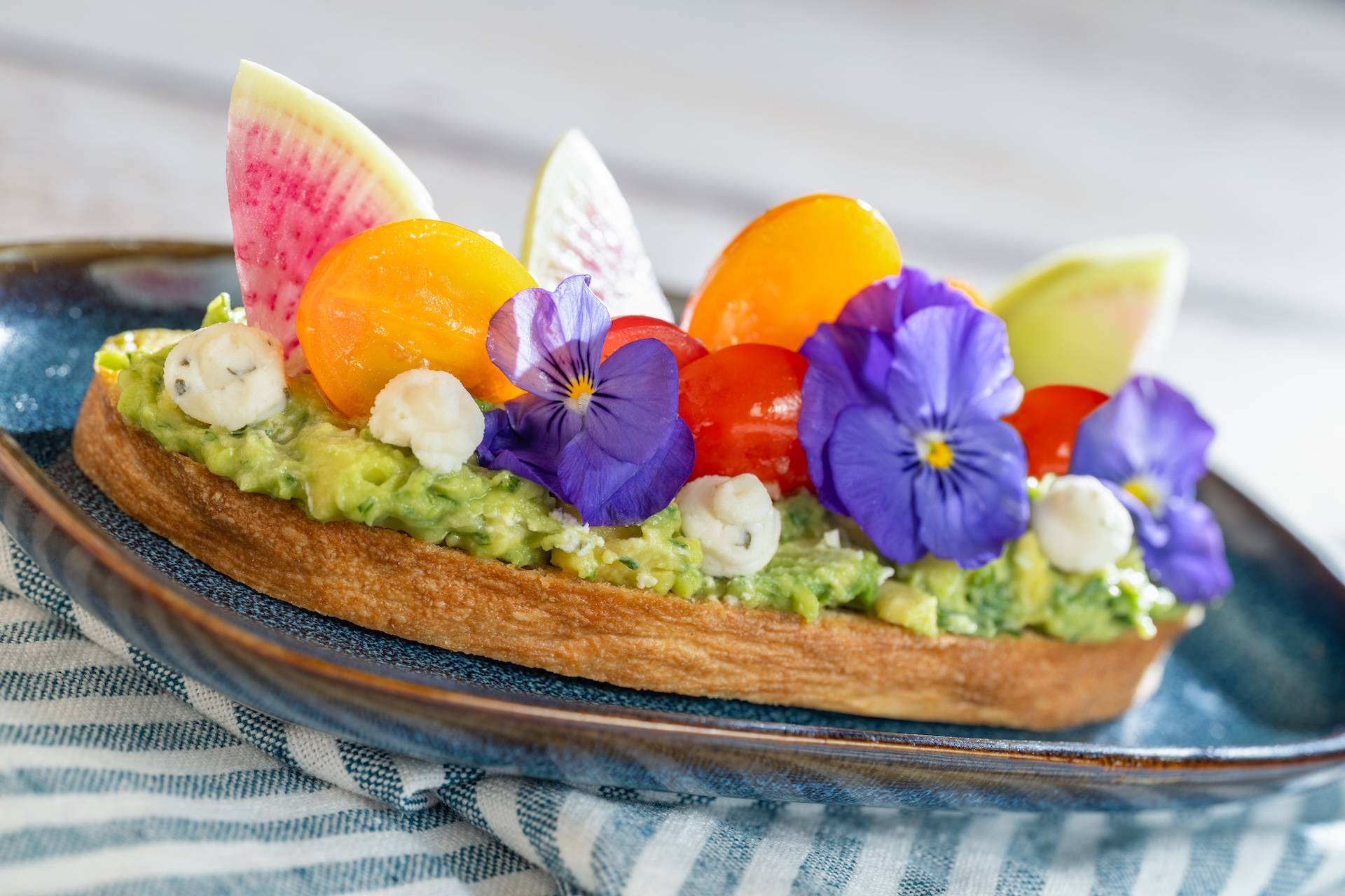 Avocado Toast with marinated tomatoes featuring Boursin Dairy-Free Garlic and Fine Herbs Cheese on toasted ciabatta