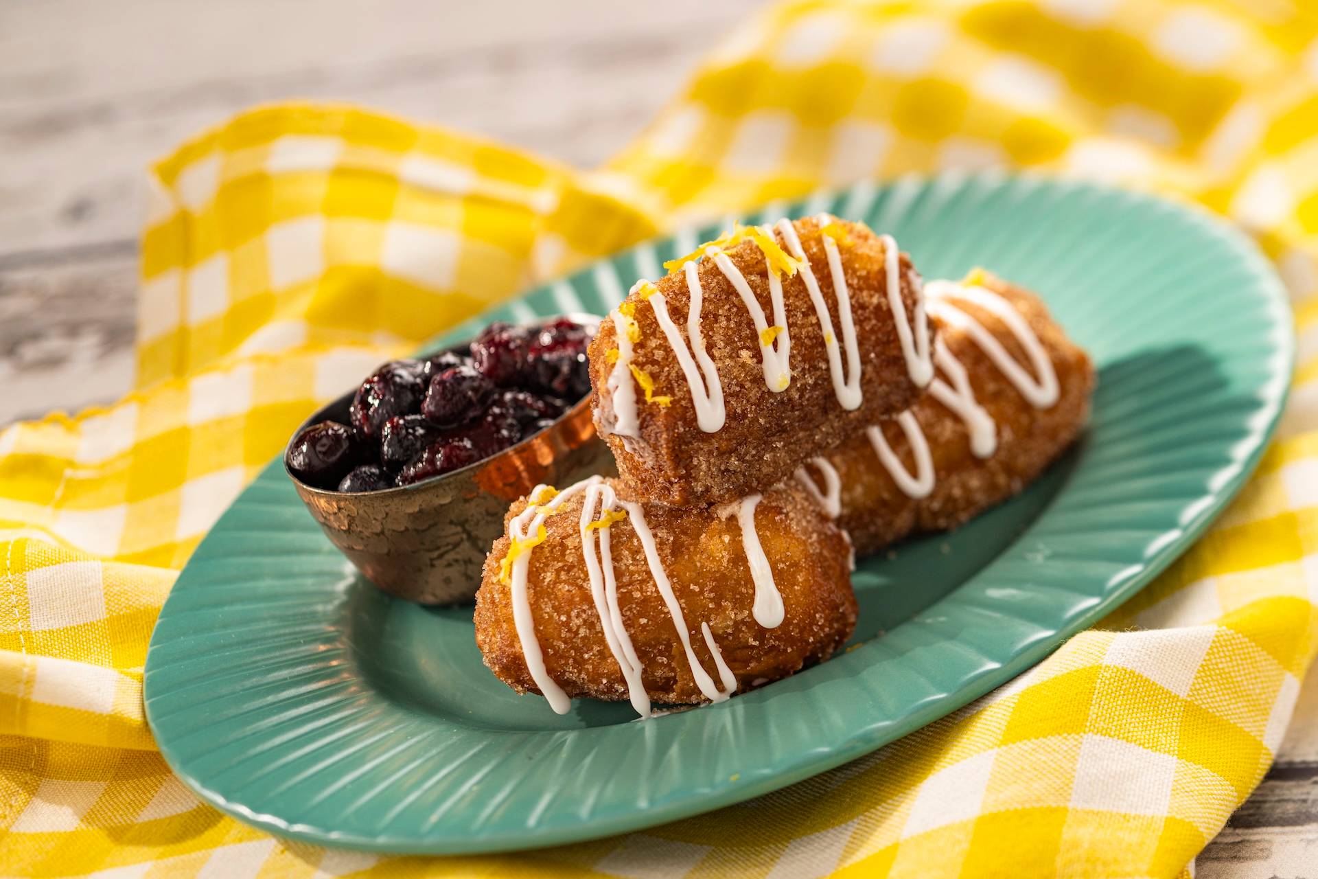 Cinnamon Beignets tossed in lemon sugar, lemon glaze, and honey mead-blueberry compote (New)