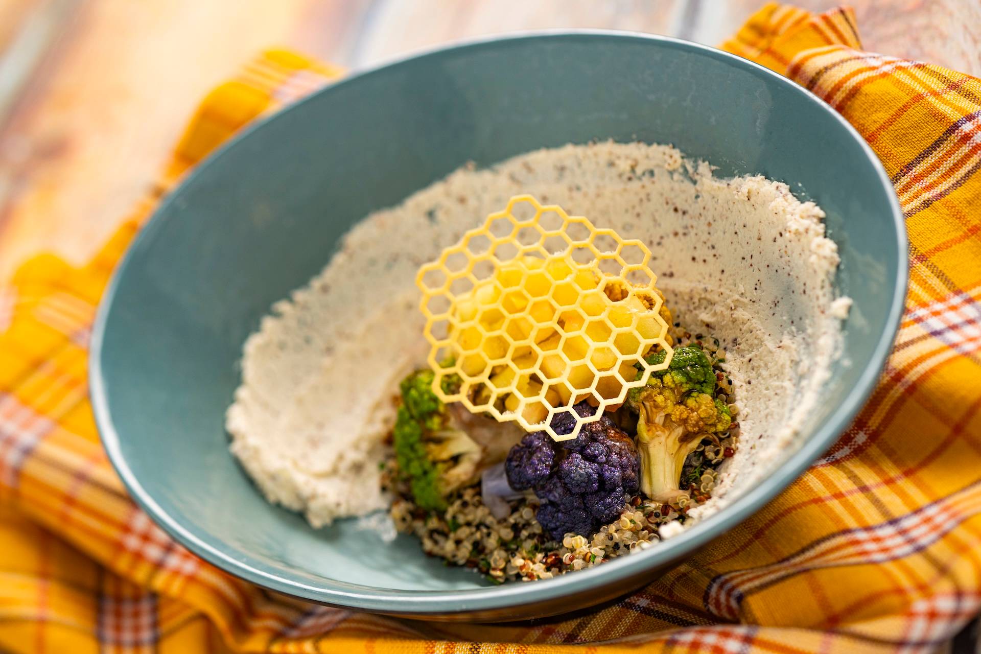 Honeycomb Bowl with herb quinoa, honey-whipped goat cheese, poached apples, and hot honey cauliflower topped with a honey tuile (New)