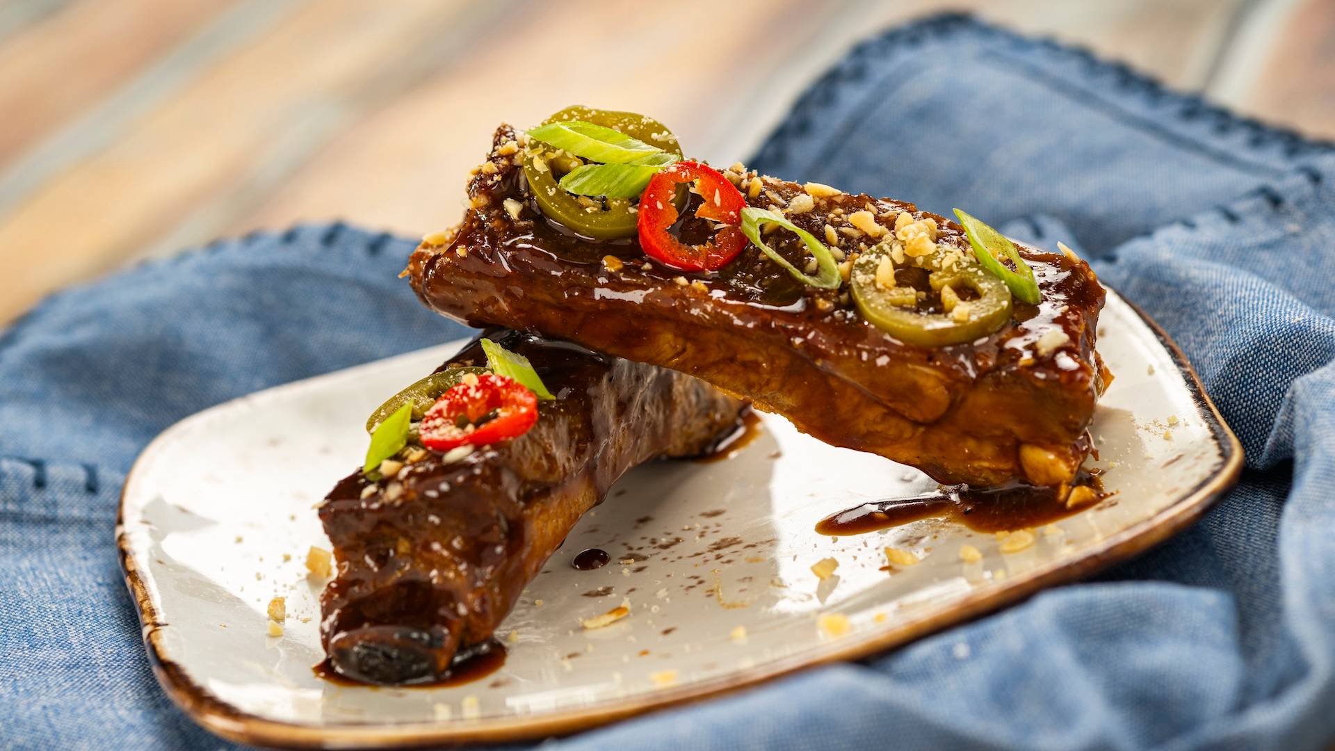 Miso Cola-glazed Sticky Pork Ribs topped with spicy pickled peppers and peanuts (New)