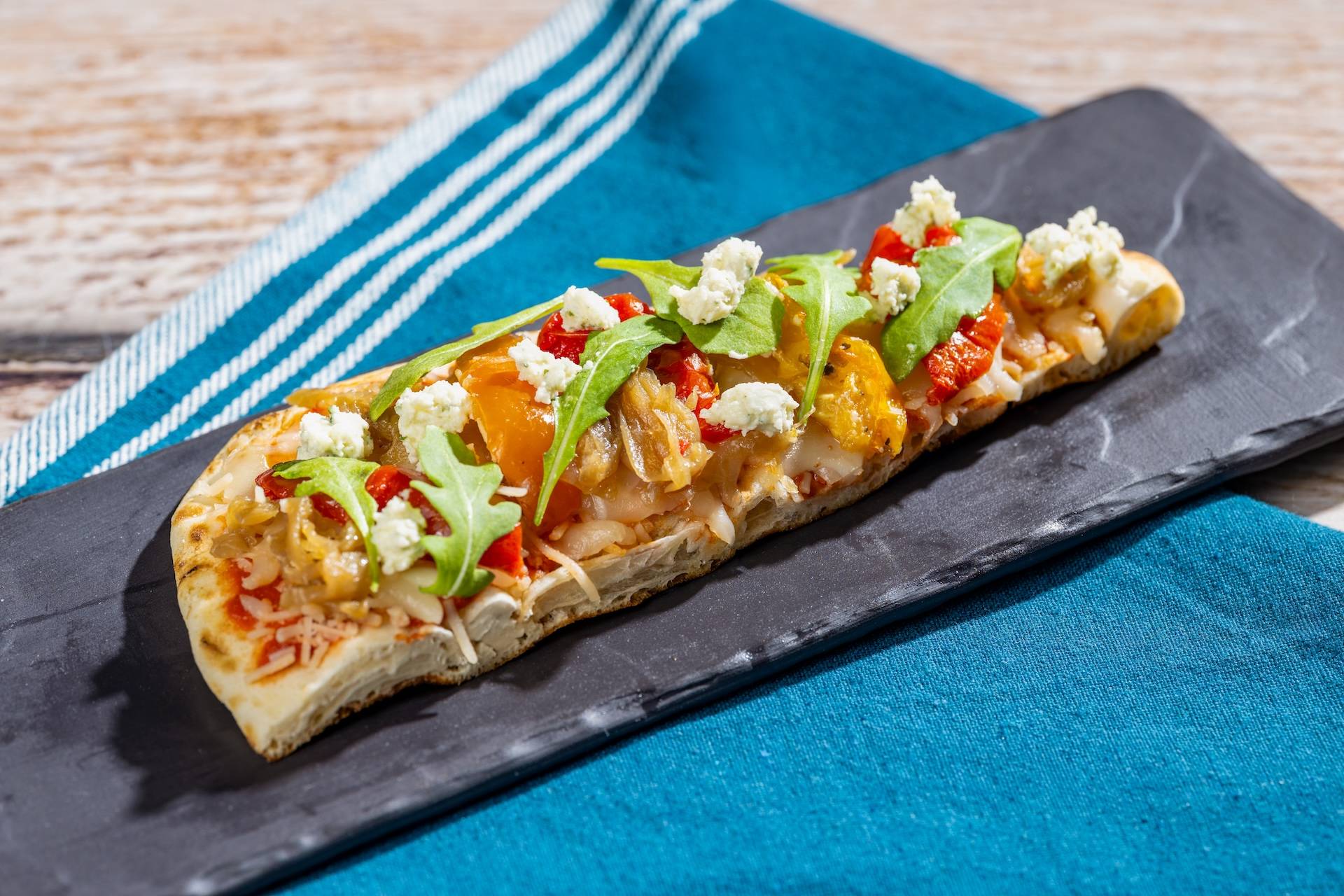 Garden Vegetable Flatbread featuring Boursin Crumbles Garlic and Fine Herbs Cheese topped with roasted vegetables and arugula salad (New)