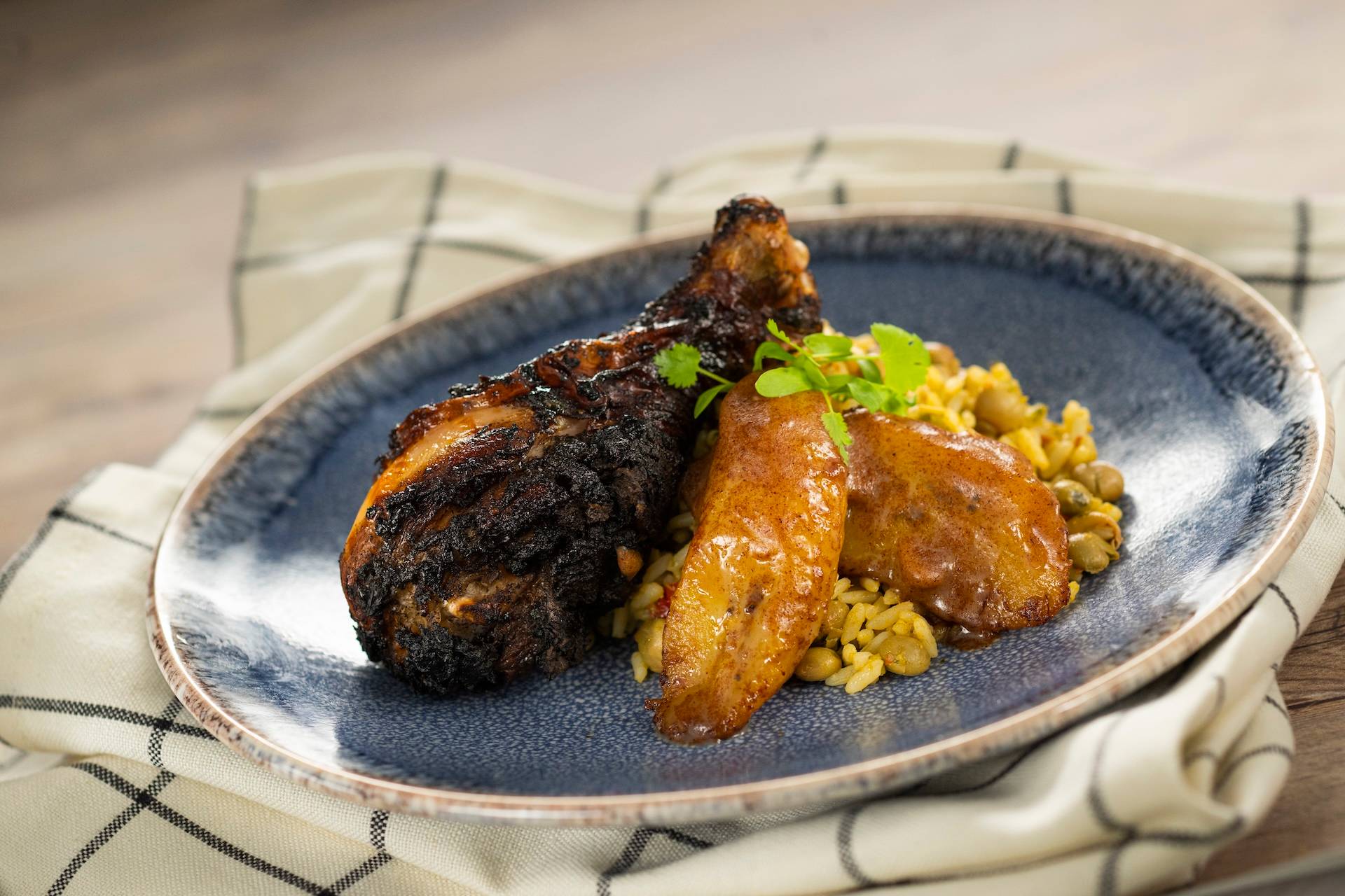 Jamaican Jerk Chicken with pigeon pea rice, roasted sweet plantains, and cinnamon butter