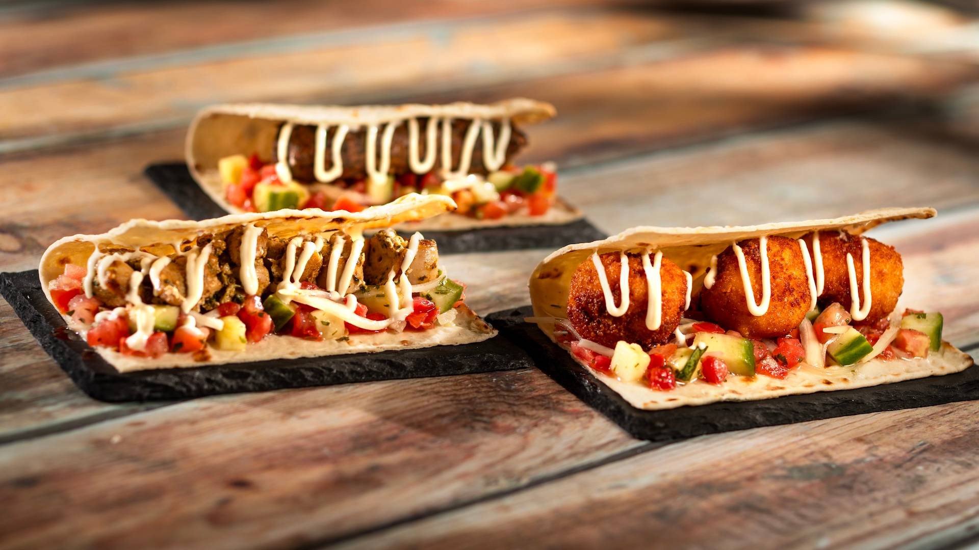 Moroccan Wrap with tomato-cucumber relish and garlic sauce served on warm Moroccan flatbread