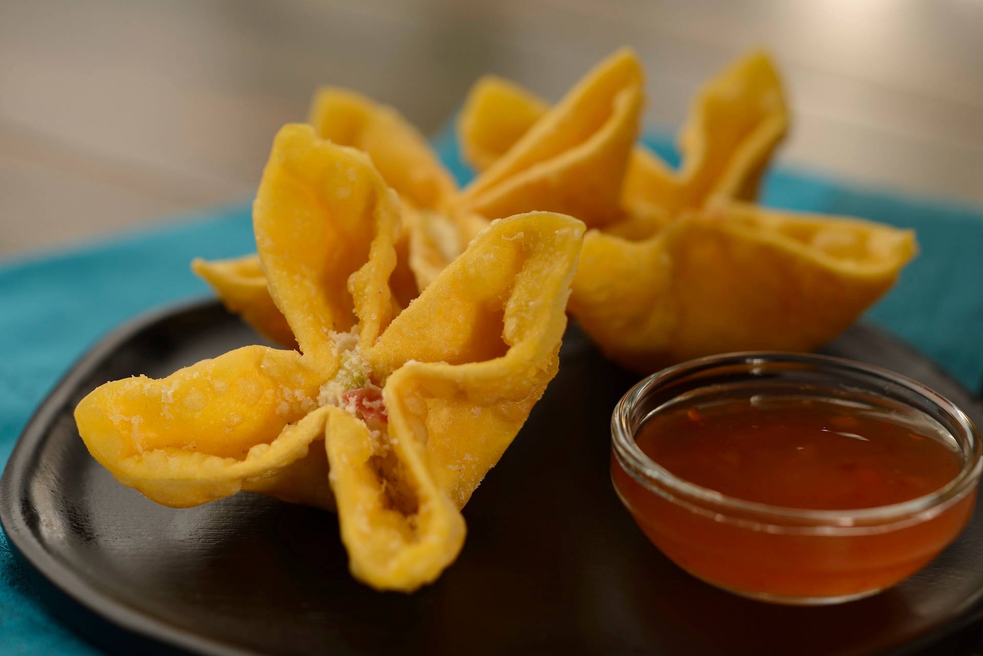 House-made Cheesy Crab Wontons: Fried wontons filled with cream cheese, celery, and imitation crab stick