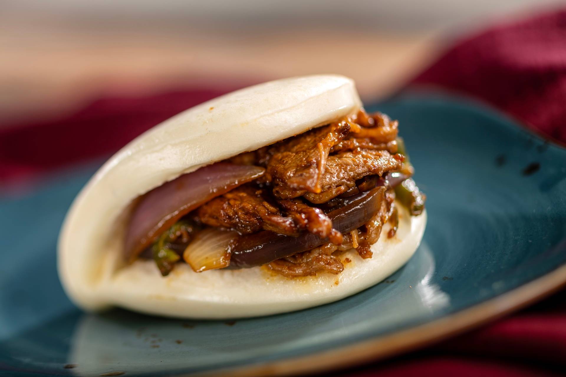 Sha Cha Beef Bao Bun filled with pan-fried beef, red onion, and jalape&ntilde;o in Chinese sha cha peanut sauce (New)