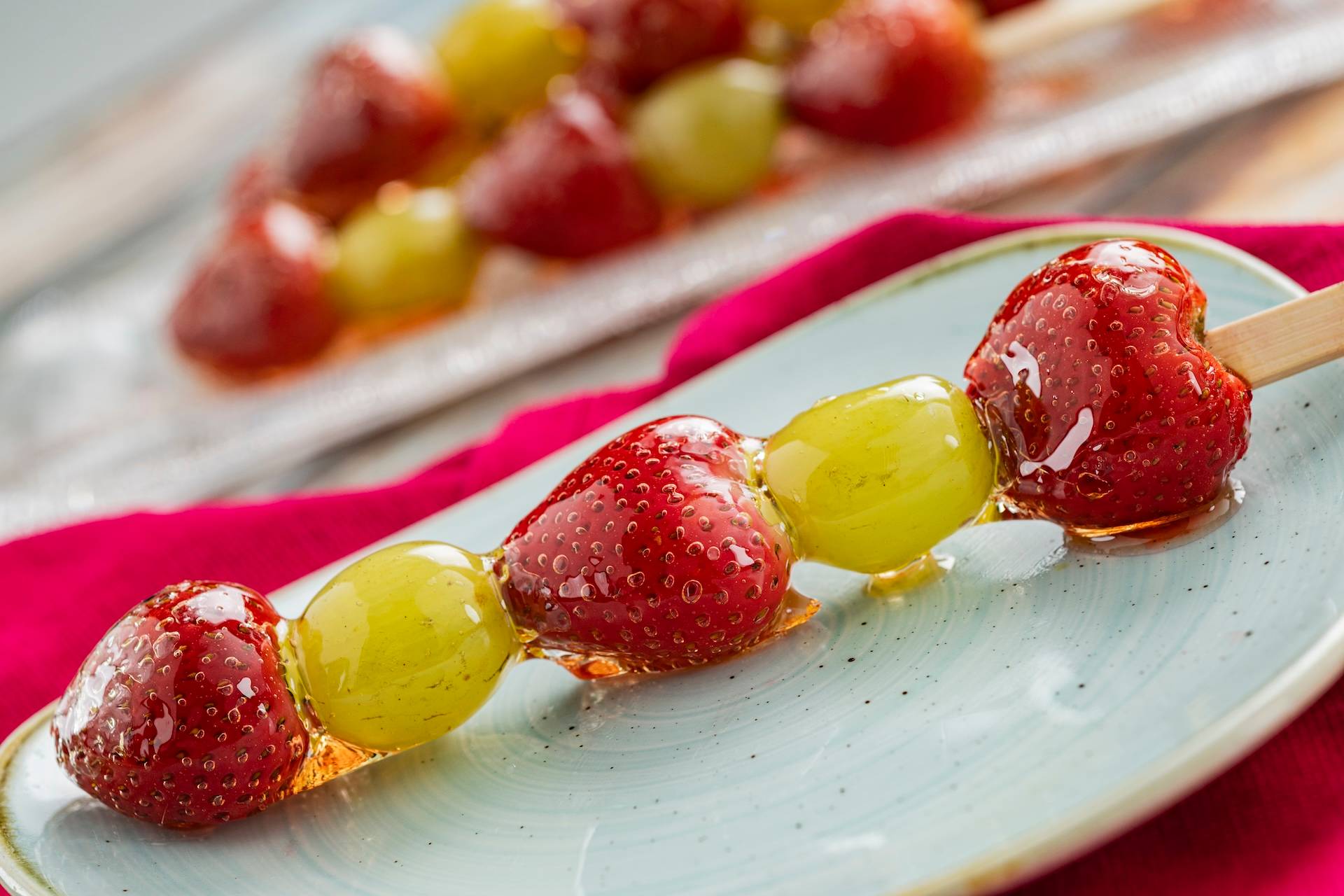 Tanghulu: Skewer of strawberries and grapes coated in candied sugar syrup (New)