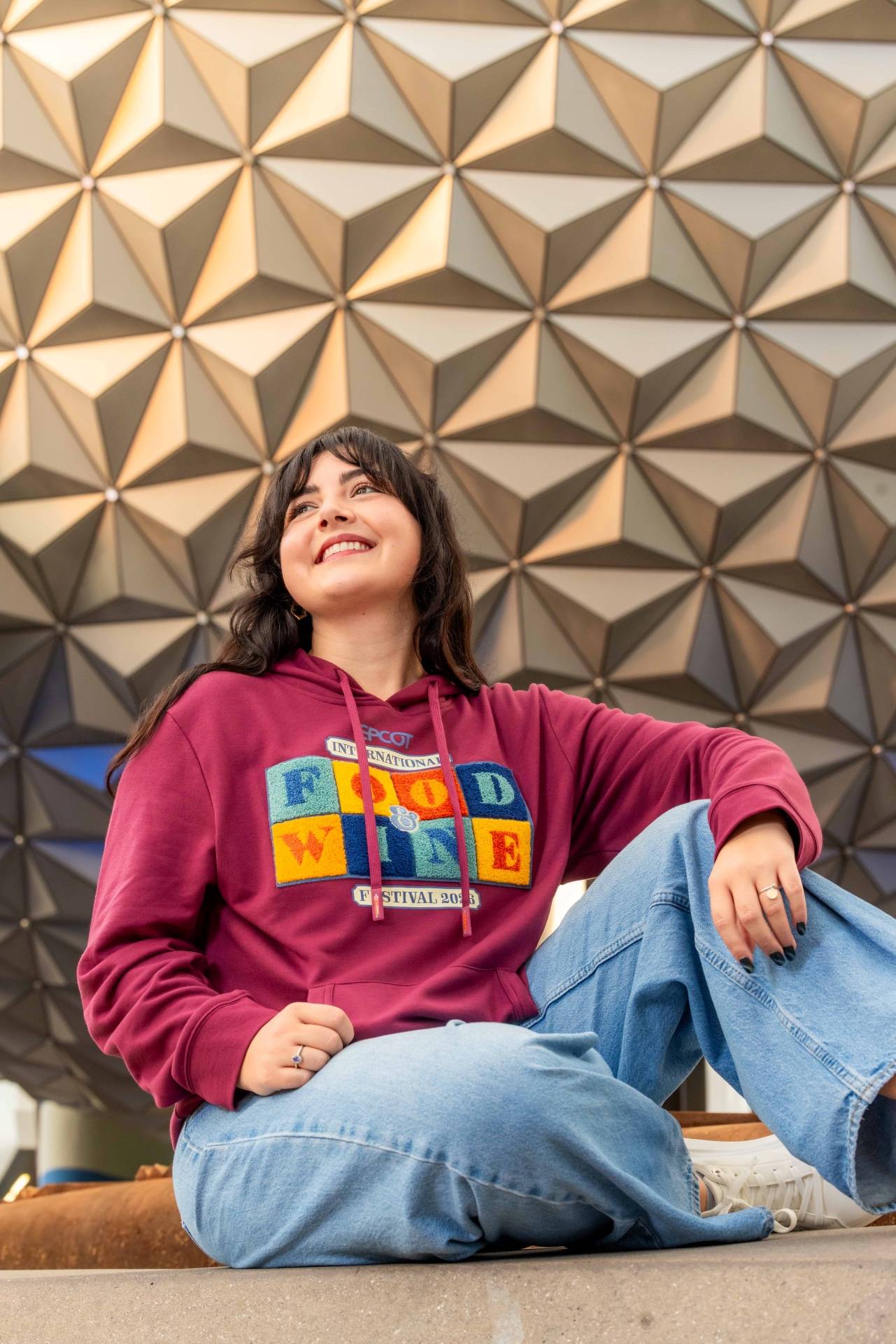 Maroon EPCOT International Food & Wine Festival 2026 hoodie modeled in front of Spaceship Earth