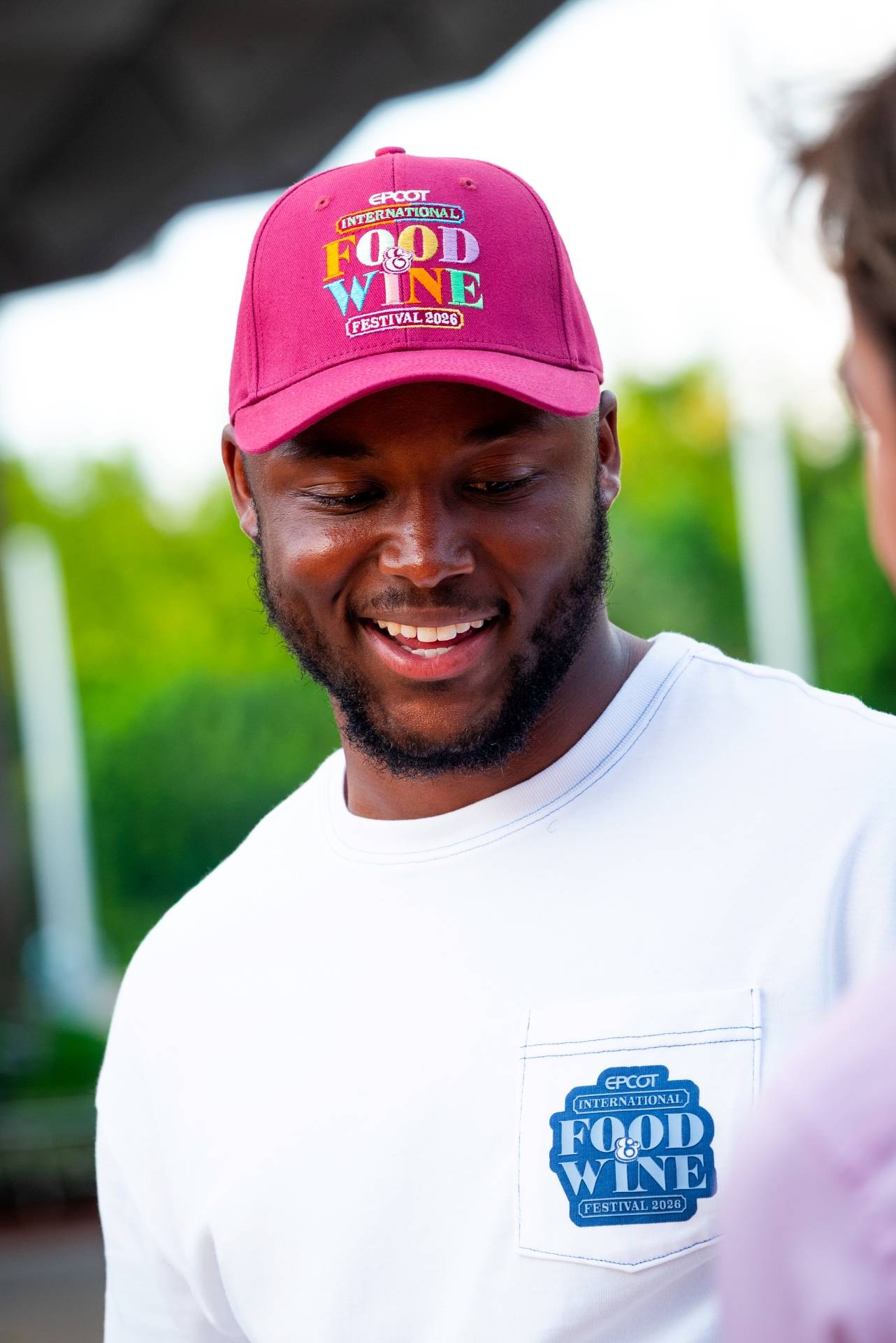 Maroon EPCOT International Food & Wine Festival 2026 cap and white pocket tee