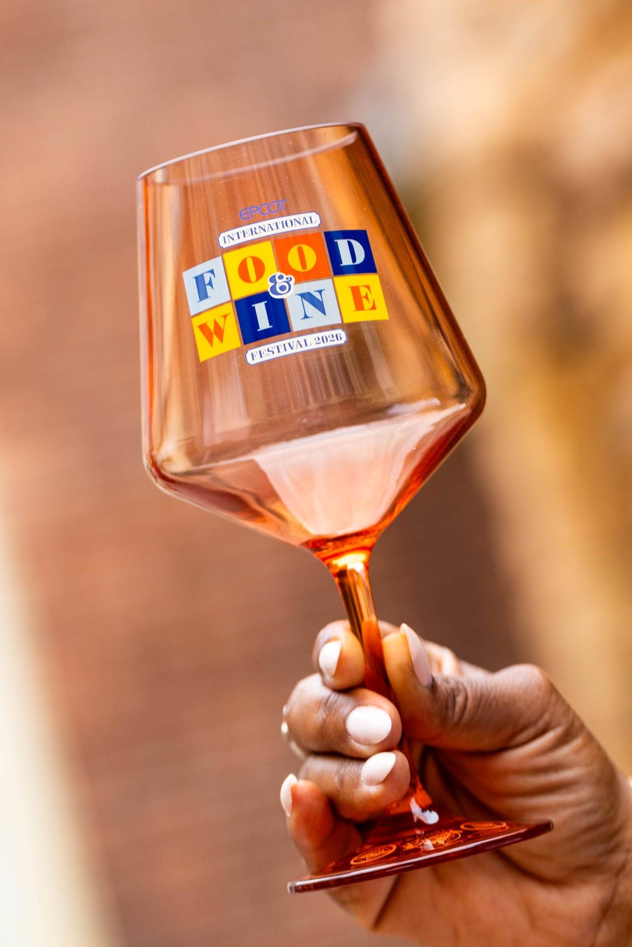 The 2026 EPCOT International Food & Wine Festival wine glass in amber-tinted acrylic