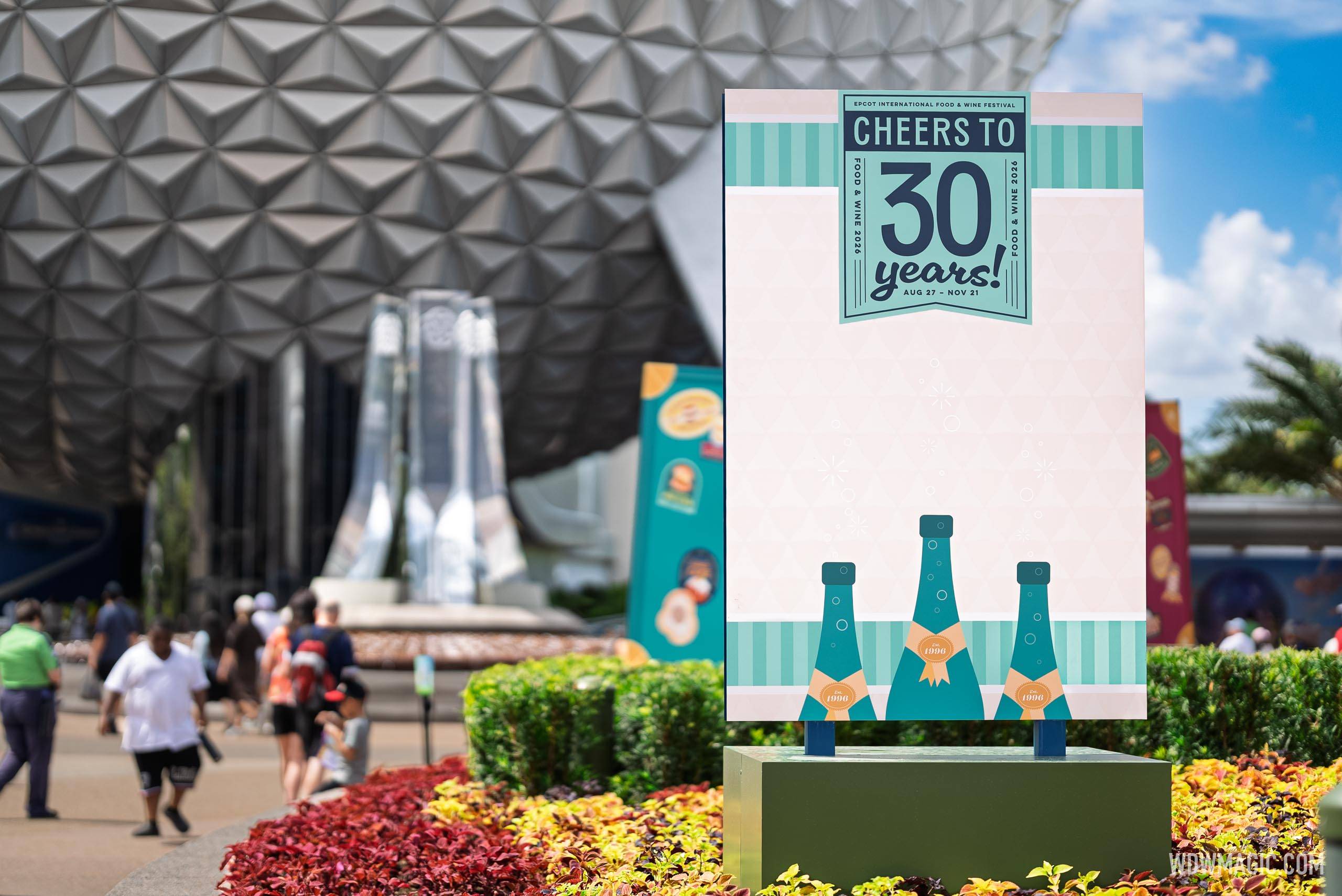 "Cheers to 30 Years" signage celebrating the Epcot International Food and Wine Festival's anniversary, displayed near Spaceship Earth with the Aug 27 – Nov 21 run dates
