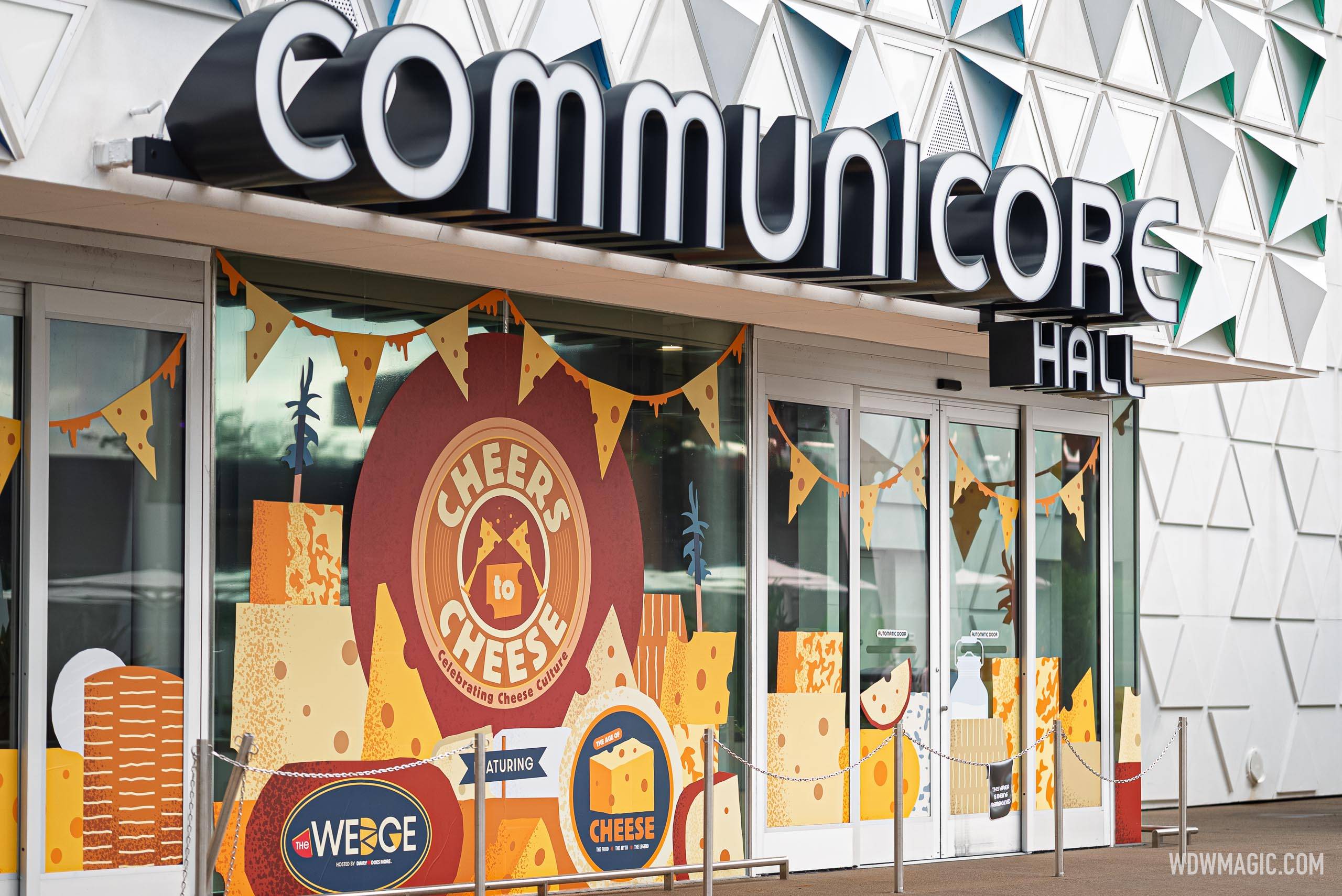 Close-up of the "Cheers to Cheese" and The Wedge branding on the CommuniCore Hall entrance windows,
