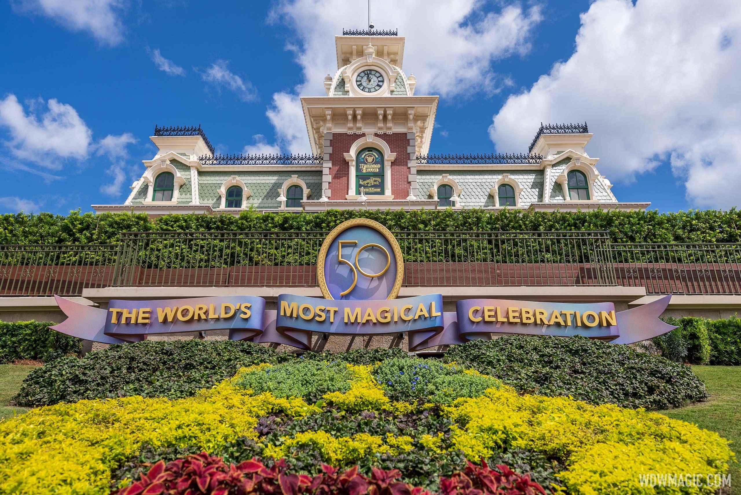 Walt Disney World 50th anniversary banner welcomes guests to the Magic Kingdom at the Main Street U.S.A. train station
