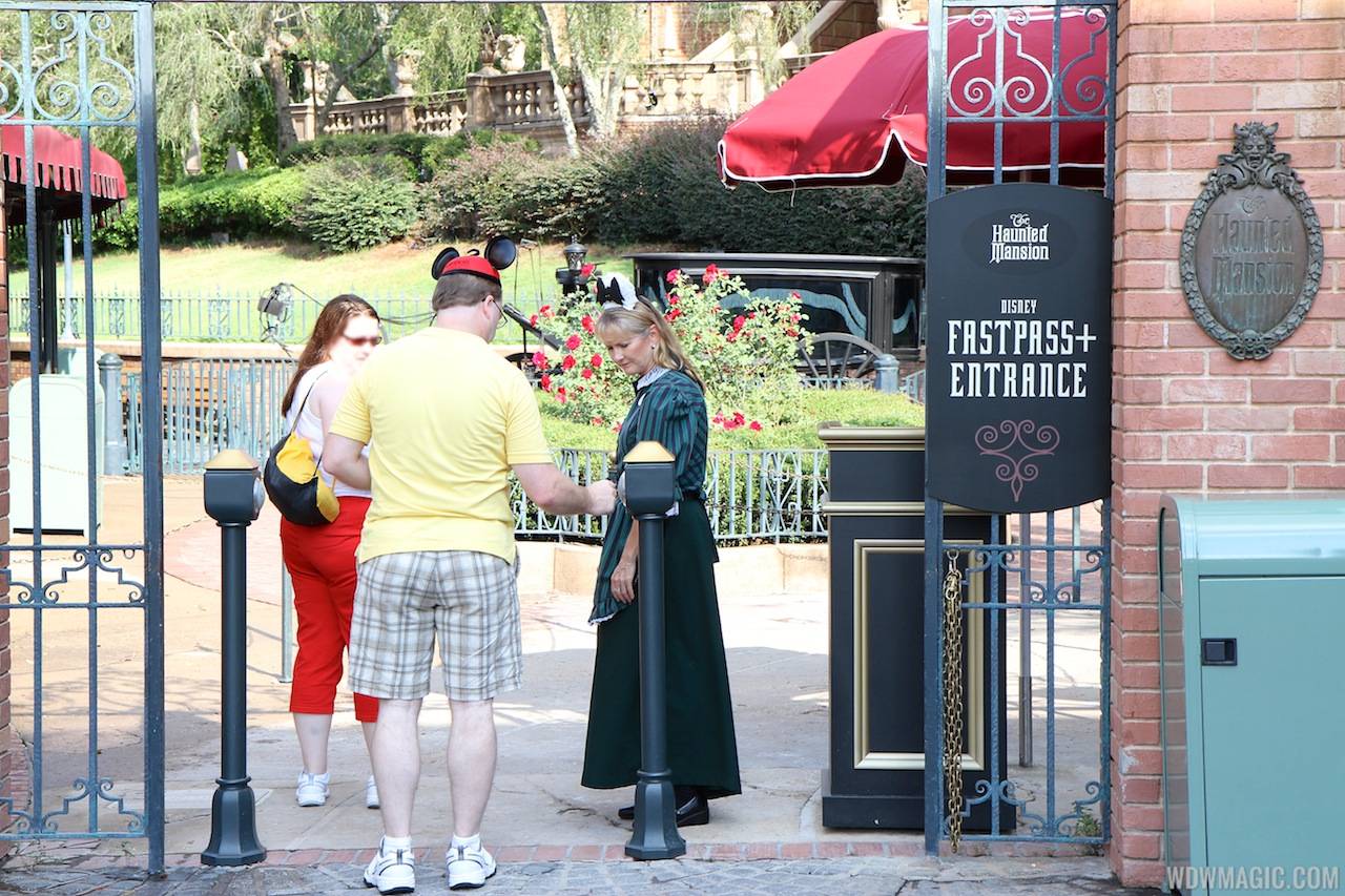 Guest using FASTPASS+ RFID reader at the Haunted Mansion