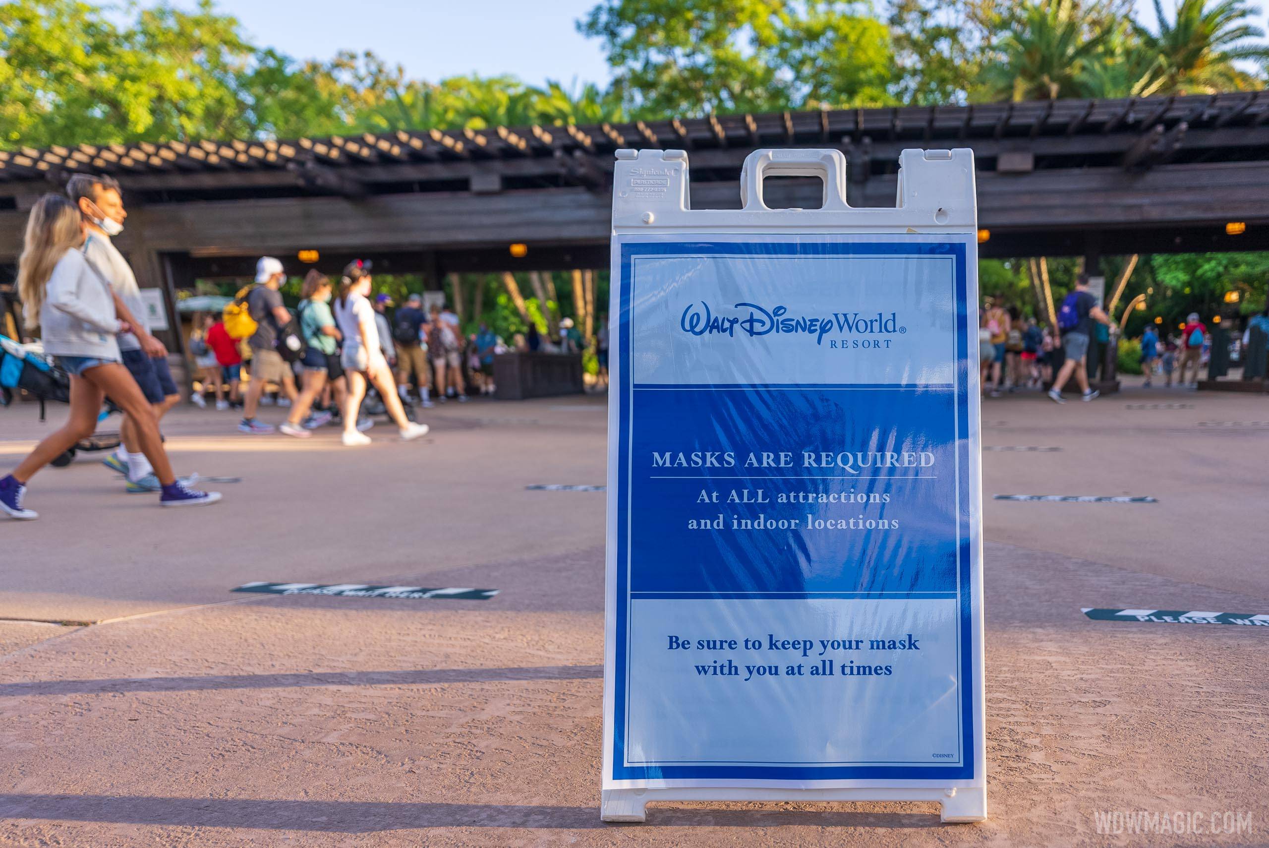 Signage from May 2021 when Disney relaxed outdoor masking but still required indoor masking