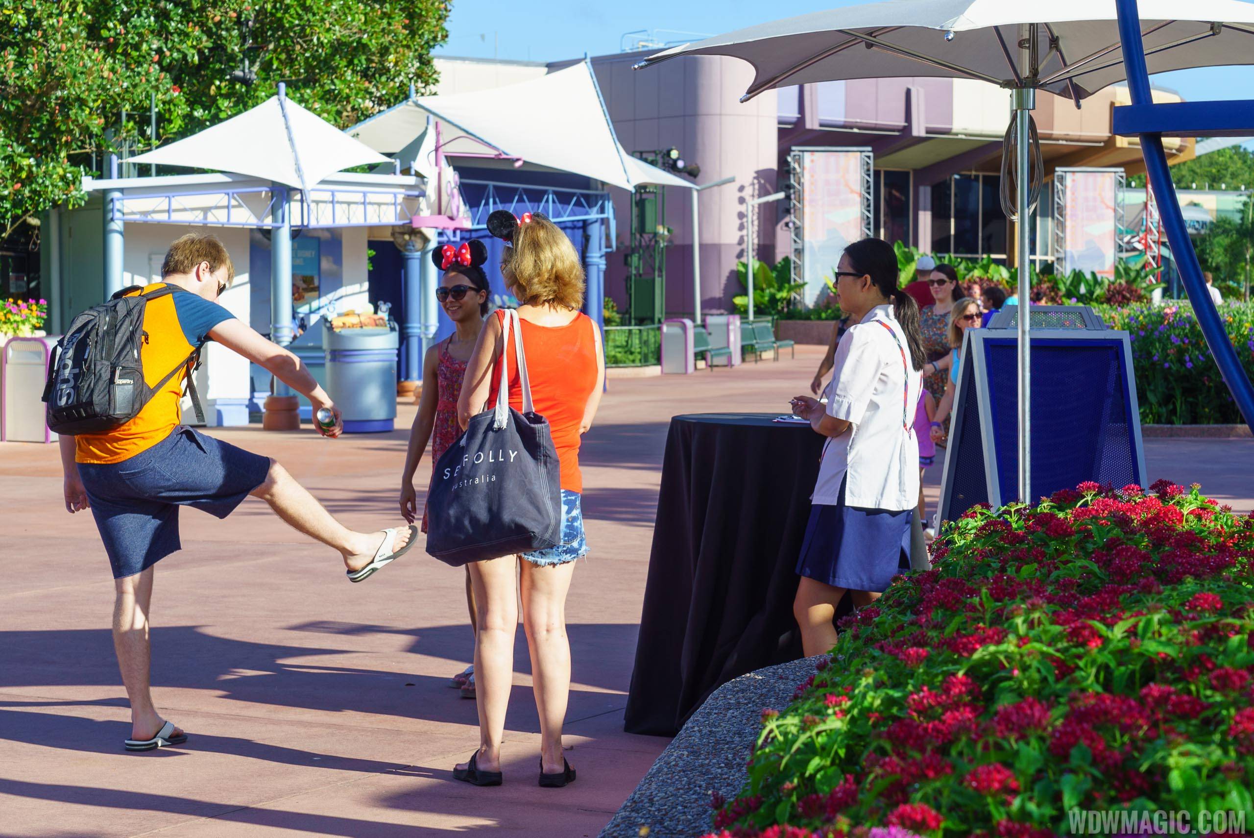 Guests making use of the complimentary insect repellent at Epcot