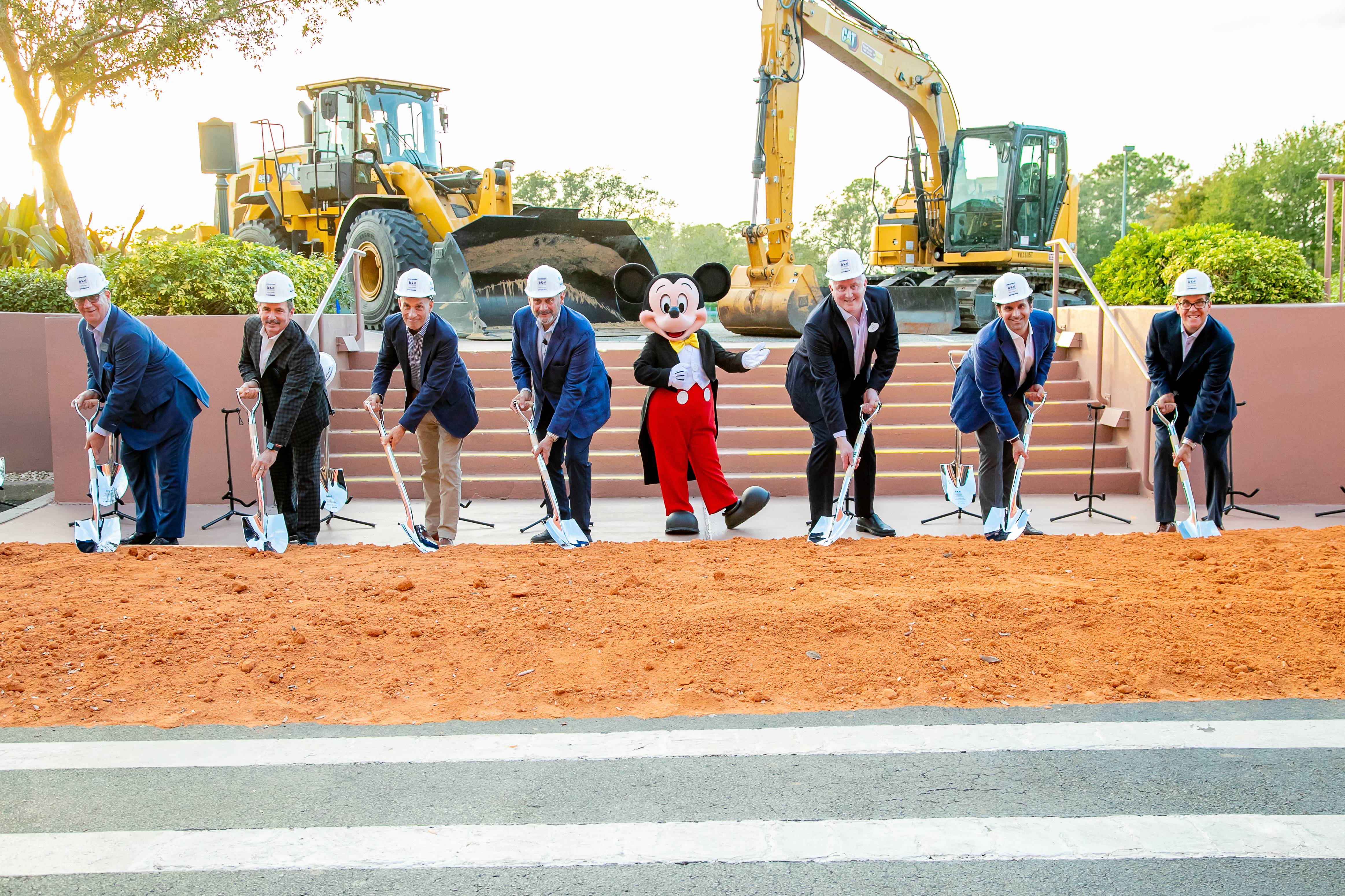 Executives from Tishman, MetLife, Marriott International and Walt Disney World Resort came together for the groundbreaking of the latest expansion to the Walt Disney World Swan and Dolphin. Pictured from the left, Walt Disney World Swan and Dolphin Area General Manager Sean Verney, Walt Disney World Swan and Dolphin Director of Sales and Marketing Jim Curtis, Tishman Realty & Construction Principal and CEO John Vickers, Tishman Realty & Construction Principal and Chairman Dan Tishman, Mickey Mouse, The Walt Disney Company Executive Vice President of Global Development Andy Hopkins, MetLife Director of Investments Scott Hochman and Marriott International Area Vice President Mark Gaber.
