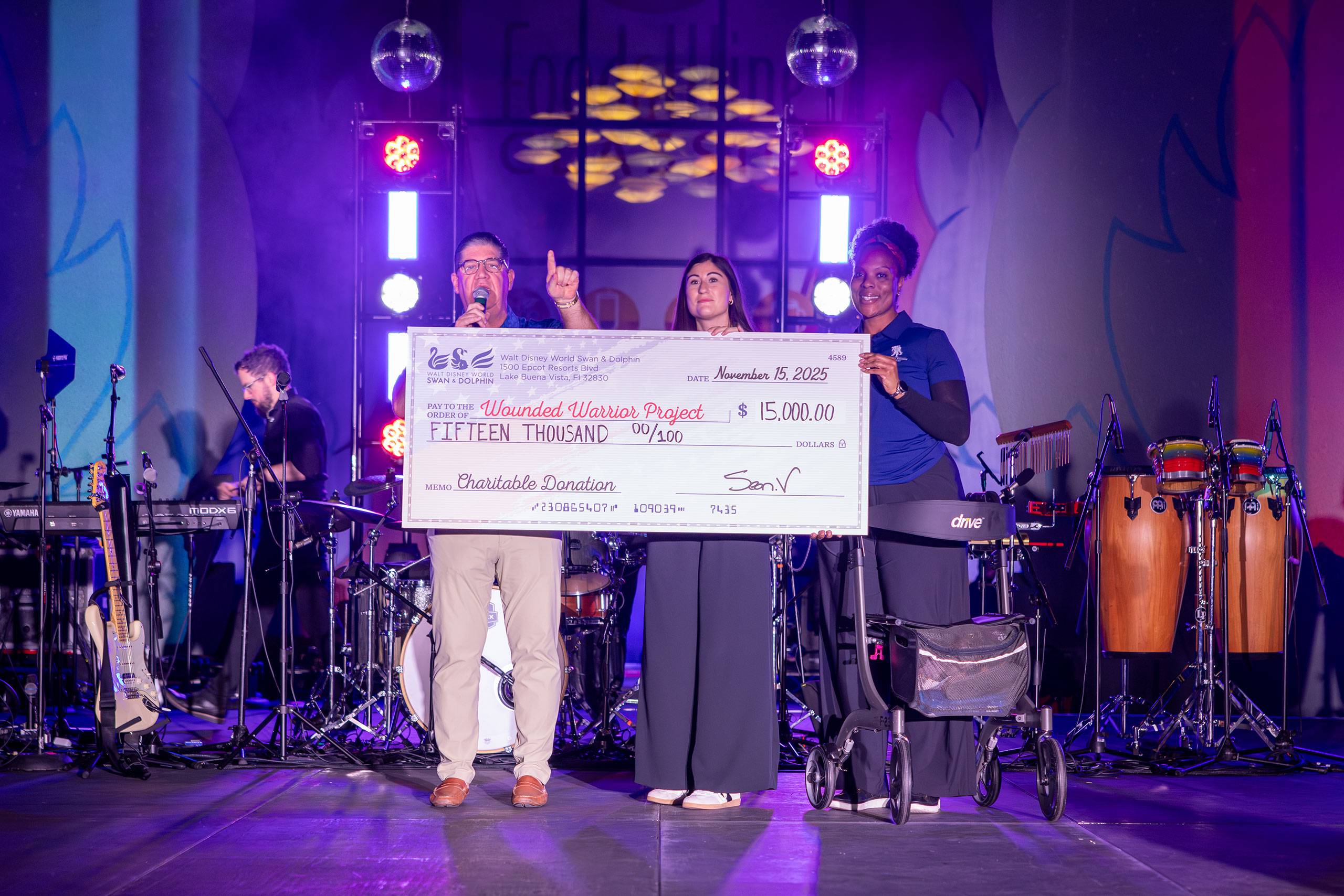 Walt Disney World Swan and Dolphin Area General Manager and U.S. Military Veteran Sean Verney (left) presents Wounded Warrior Project Community Fundraising Manager Savannah Simmons and veteran Sharona Young with a donation of $15,000 from proceeds raised at the 16th annual Swan and Dolphin Food and Wine Classic.