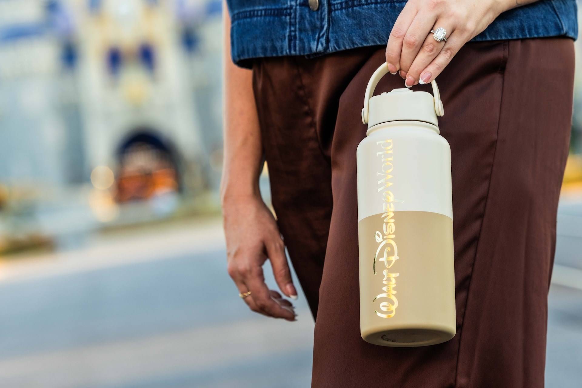 The cream and gold Walt Disney World Logo Mania water bottle in the Storybook Soft Serve colorway, available November 1