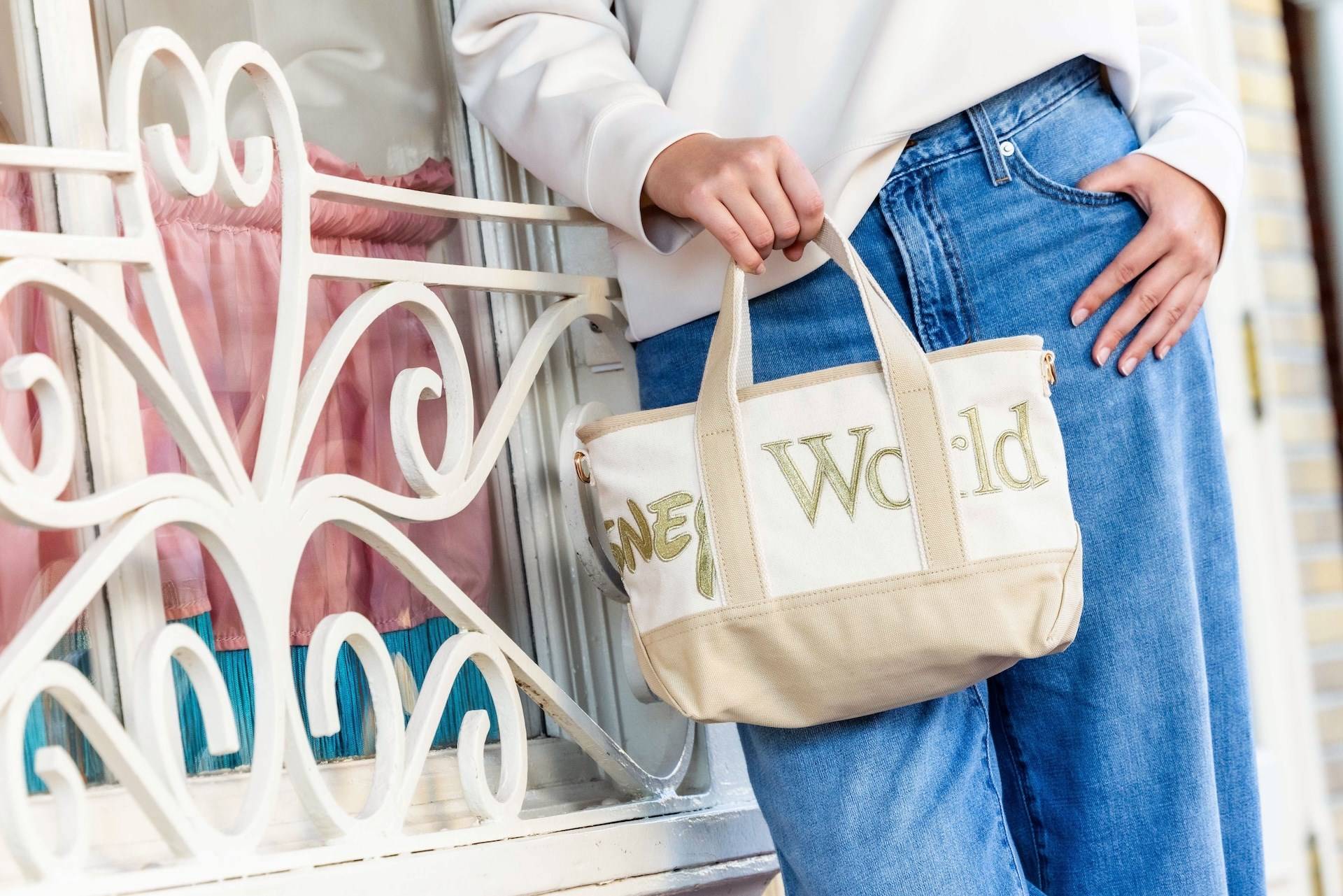 The cream and gold Walt Disney World Logo Mania mini tote bag in the Storybook Soft Serve colorway
